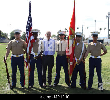 Left to right, Marine Corps Recruiters Sgt. Elijah Gable, Sgt. Derrick Berrian, Mr. Dennis Mulhaupt, president of St. John Bosco High School, SSgt. Phillip Page, Sgt. Victor Romualdo and LCpl. Ulixes Hernandez, pose during a varsity baseball game at St. John Bosco High School, Bellflower, Calif., March 14, 2017. Coming from Recruiting Substation Lakewood, the recruiters were the official color guard for the game. Stock Photo