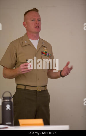 U.S. Marine Capt. Scott L. Campbell, maintenance officer with Marine Aviation Weapons and Tactics Squadron One (MAWTS-1) welcomes students attending the first ever Advanced Aircraft Maintenance Officer Course (AAMOC) at Marine Corps Air Station Yuma, Ariz., on Mar. 13, 2017. AAMOC will empower Aircraft Maintenance Officers with leadership tools, greater technical knowledge, and standardized practices through rigorous academics and hands on training in order to decrease ground related mishaps and increase sortie generation. (U.S. Marine Corps photo taken by Cpl. AaronJames B. Vinculado)