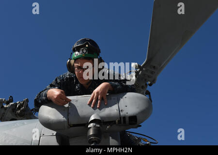 170311-N-OS584-006 SAN DIEGO (Mar. 11, 2017) Aviation Structural Mechanic 3rd Class Taylor Adam of Helicopter Squadron Combat 3 completes final maintenance on an MH60-S helicopter on the flightline at Naval Air Station North Island, Coronado, Calif. (U.S. Navy photo by Mass Communication Specialist 1st Class Jimmie Crockett/Released) Stock Photo
