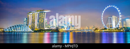 Panorama of Singapore city skyline by night Stock Photo