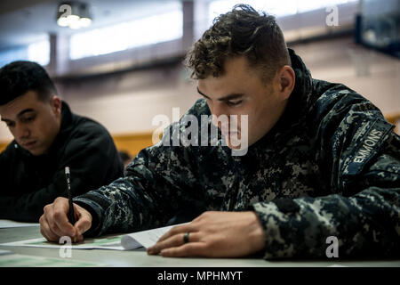 170316-N-OI810-031  YOKOSUKA, Japan (March 16, 2017)  Aviation Ordnanceman Airman Joshua Emmons, assigned to the aircraft carrier USS Ronald Reagan (CVN 76), takes the Navy-wide E-4 advancement exam at James D. Kelly Fleet Recreation Center. Ronald Reagan is the flagship of Carrier Strike Group 5, providing a combat-ready force that protects and defends the collective maritime interests of its allies and partners in the Indo-Asia-Pacific region. (U.S. Navy photo by Mass Communication Specialist 2nd Class Nathan Burke/Released) Stock Photo