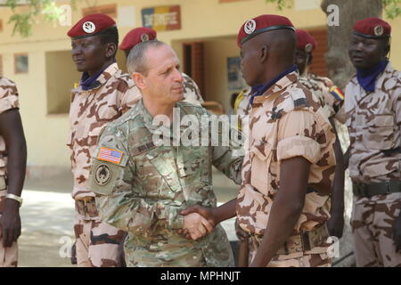 Brig. Gen. Donald Bolduc, commander, Special Operations Command Africa, greets Chadian personnel participating in the Flintlock 2017 closing ceremony March 16, 2017 in N'Djamena, Chad. Flintlock is an annual special operations exercise involving more than 20 nation forces that strengthens security institutions, promotes multinational sharing of information, and develops interoperability among partner nation in North and West Africa. (U.S. Army photo by Richard Bumgardner) Stock Photo