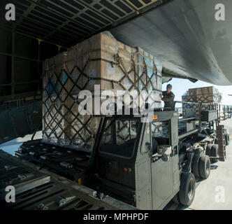 Senior Airman Elias Wilson, 22nd Airlift Squadron, loads pallets of unaccompanied baggage at Osan Air Base, South Korea, March 7, 2017. The pallets of unaccompanied baggage were returned back to the United States for service members who are being reassigned. (U.S. Air Force photo by Staff Sgt. Nicole Leidholm) Stock Photo