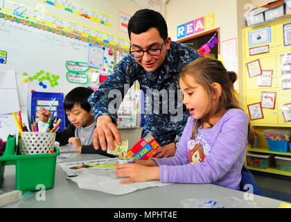 170316-N-YG414-105  YOKOSUKA, Japan (March 16, 2017) Seaman Jonathon Nava, assigned to the U.S. 7th Fleet flagship USS Blue Ridge (LCC 19), pasrticipates in a math exercise during a community relations event at Sullivan's Elementary School. Blue Ridge is in an extensive maintenance period in order to modernize the ship to continue to serve as a robust communications platform in the U.S. 7th Fleet area of operations. (U.S. Navy photo by Mass Communication Specialist Seaman Patrick Semales/Released) Stock Photo