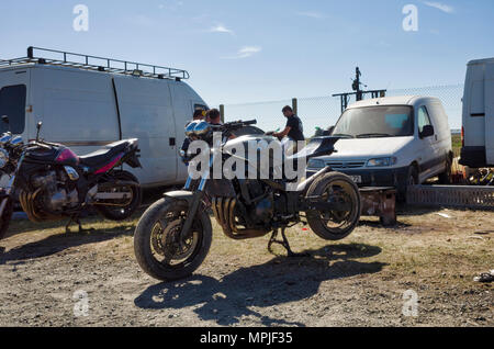 19-20th May 2018. Le Mans, France.  Behind the scenes at the MotoGP.  An abused motorcycle has been parked up with the tell tail signs of a shredded rear tire and large exhaust end-can that has no silencer to make the engine run incredibly loud. Stock Photo