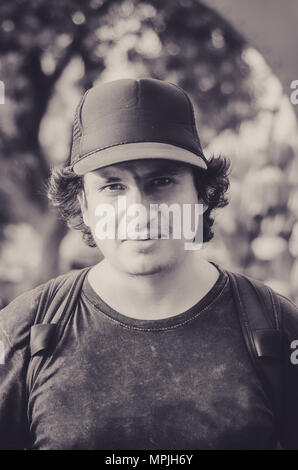 A portrait of the long-haired young man with backpack Stock Photo