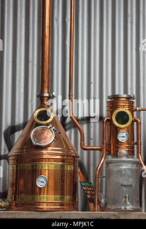 a copper whisky or gin spirits still at a micro brewery or distillery producing alcohol. Equipment used as a still for producing gins and whiskey home Stock Photo