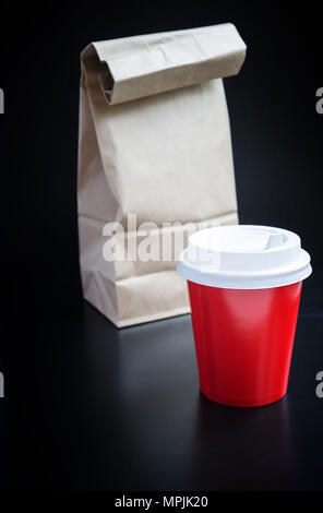 Red coffee cups on black background. Coffee to go Stock Photo