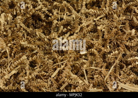 Close up of crinkled shredded brown paper box filler for shipping fragile items to prevent damage and breakage Stock Photo
