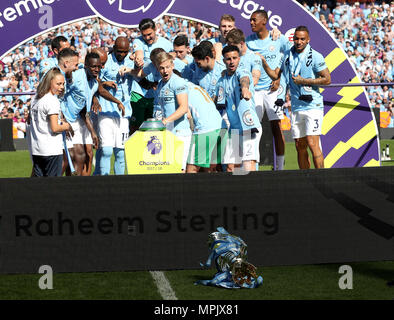 The Premier League trophy takes a tumble as Manchester City's Alexander Zinchenko (centre) and Kyle Walker (centre right) look on with team-mates Stock Photo