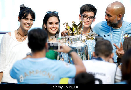 Pep Guardiola (right) celebrates with the trophy and wife Cristina Serra (left) and family Stock Photo