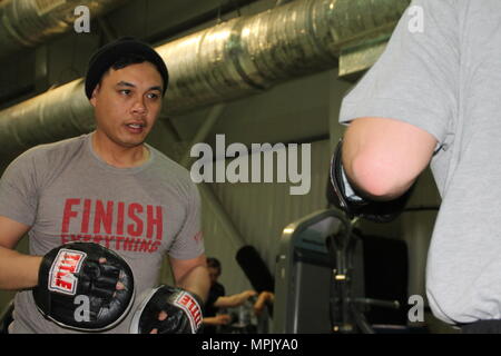 Sgt. 1st Class Joel Vallete, section signal chief with 1st Battalion, 8th Infantry Regiment, 3rd Armored Brigade Combat Team, 4th Infantry Division, leads nightly circuit training exercises and sparring sessions at a gymnasium at Mihail Kogalniceanu Air Base, Romania, March 8, 2017. Vallete has been boxing for 10 years and coaching since 2013, and despite being deployed 6,500 miles from home station Fort Carson, Colorado, for Operation Atlantic Resolve, he has brought the training forward and encouraged other service members stationed at the Romanian base to join in the training. (U.S. Army ph Stock Photo