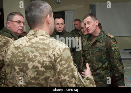 German Brig. Gen. Kai Rohrshneider, chief of staff for U.S. Army Europe, is briefed by a Ukrainian officer about the improvements to range operations at the Yavoriv Combat Training Center on the International Peacekeeping and Security Center, near Yavoriv, Ukraine, on March 21. (Photo by Sgt. Anthony Jones, 45th Infantry Brigade Combat Team) Stock Photo