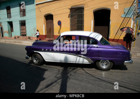 Beautifully restored Classic American 1950's car drives the streets of Trinidad Cuba Stock Photo