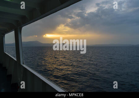 Sunset sunlight breaking through cloud seascape Stock Photo