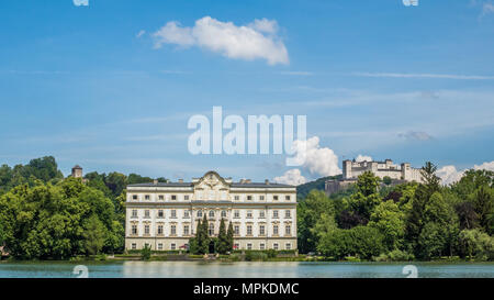 Rococo styled Leopoldskron Palace, Salzburg, Austria. Location for the film 'Sound of Music.' Fortress Hohensalzburg sits atop the Festungsberg. Stock Photo