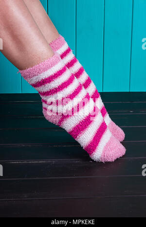 beautiful legs woman with socks standing on tiptoe on the wooden floor Stock Photo