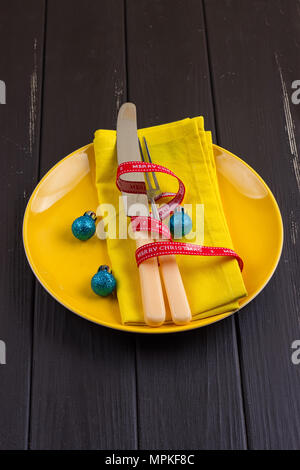 Christmas serving cutlery on plate over table Stock Photo