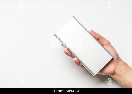 white silver power bank on hand isolate. save energy and reduce energy efficiency concept Stock Photo