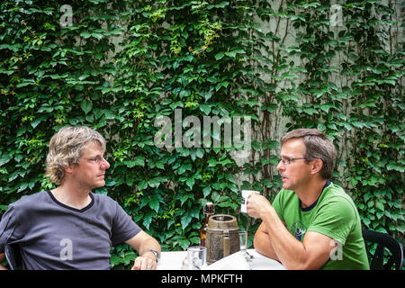 Montreal Canada,Quebec Province,rue Ontario,Chez Clo Restaurant Bistro,al fresco sidewalk outside outdoors tables,dining,men,ivy,tables,visitors trave Stock Photo