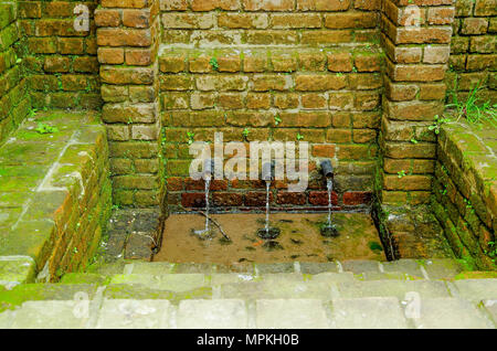 Outdoor view of old brick wall with water in colonial city Popayan Stock Photo