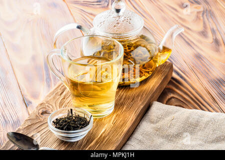 Traditional Chinese green tea beverages different fermentation glass teapot and cup with fresh brewed leaves food concept breakfast early in morning o Stock Photo