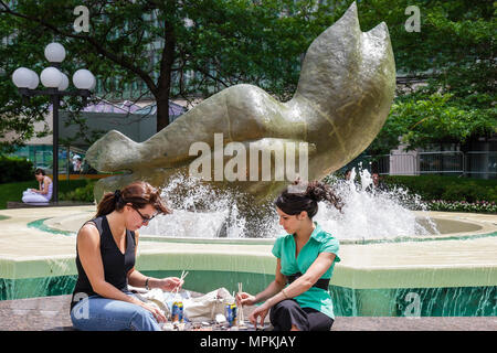 Montreal Canada,Quebec Province,Avenue McGill College,school,campus,Place Ville Marie,sculpture,fountain,public park,women,lunchtime,Canada070706101 Stock Photo