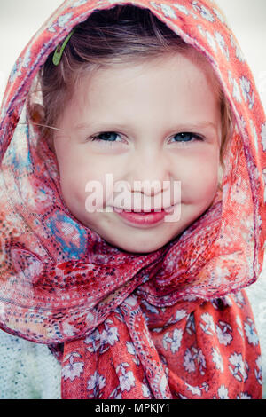 Beautiful caucasian girl child in headscarf on hot summer day - culturally appropriate / sensitive wear in Muslim / Islamic / Middle-Eastern countries