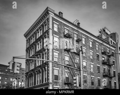 Black and white picture of an old building with fire escapes, New York City, USA. Stock Photo