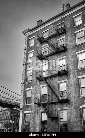 Black and white picture of an old building with fire escape, New York City, USA. Stock Photo