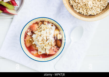 Homemade rhubarb and apple compote with coconut yogurt and oatmeal, healthy detox snack Stock Photo