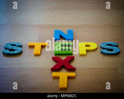 next steps concept in colorful letters on wooden blackboard Stock Photo