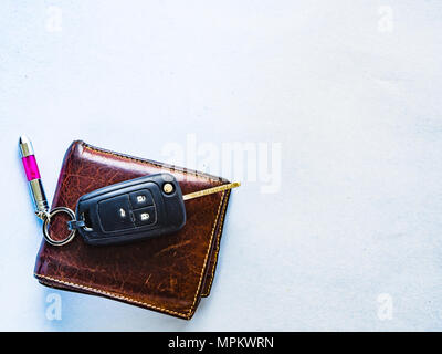 wallet and car key on white paper background with HDR preset Stock Photo