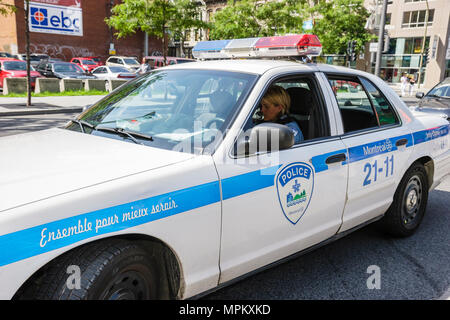Canada,Canadian,Quebec Province,French language,bilingual speaking,Montreal,police car,vehicle,law enforcement,woman female women,officer,Canada070708 Stock Photo
