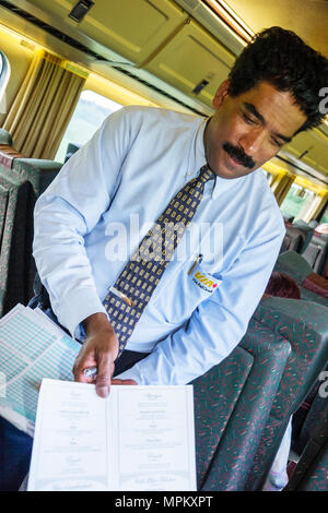 Montreal Canada,Quebec Province,VIA Rail,passenger train to Quebec City,Asian man,male porter,menu,service,Canada070708108 Stock Photo