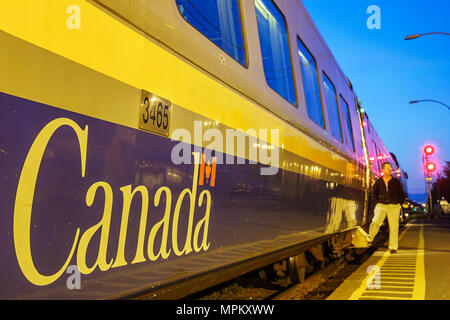 Canada,Canadian,North America,American,Charny,VIA Rail train station,VIA Rail passenger car cars,platform,dusk,evening,visitors travel traveling tour Stock Photo