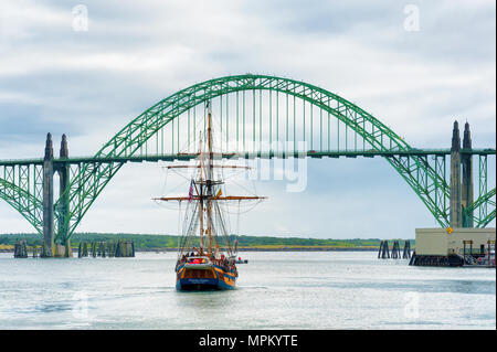 Newport, Oregon,USA - May 25, 2016: Hawaiian Cheiftain motors near Yaquina Bay Bridge in Newport, Oregon, where it will turn and raised it sails then  Stock Photo