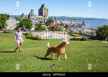Quebec Canada,Upper Town,Parc de l'Esplanade,St. Lawrence River,Fairmont Le Chateau Frontenac,woman female dog park,Canada070712016 Stock Photo