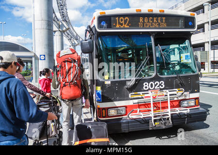 Toronto Canada,Lester B. Pearson International Airport,YYZ,TTC,public bus,coach,transportation,mass transit,stop,Asian woman female women,man men male Stock Photo