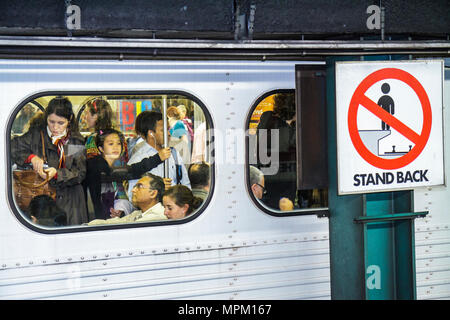Toronto Canada,TTC subway,Bloor Yonge Station,Yonge Yellow Line,passenger passengers rider riders,commuter,commuters,crowded train,window,Asian woman Stock Photo