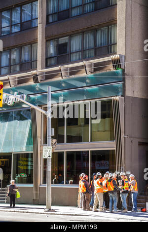 Toronto Canada,Carlton Street,street,sidewalk,man men male adult adults,under new construction site building builder,worker,workers,laborer,hard hat,r Stock Photo