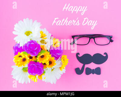 Father's day concept. Happy Father's Day and I LOVE DAD message on note book with pink flower, coffee cup, white gift and black Mustache on pink backg Stock Photo