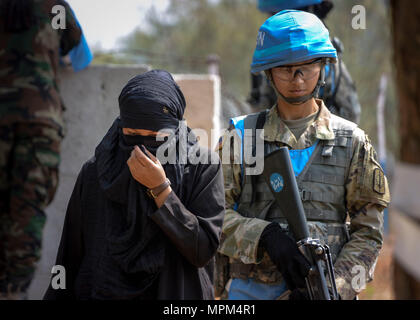 Spc. Maria Hutchinson a Soldier assigned to the 57th Military Police Company, 8th Military Police Brigade from Scofield Barracks in Hawaii escorts a role player to a personal search station during a training event at exercise Shanti Prayas III in Nepal. Shanti Prayas is a multinational United Nations peacekeeping exercise designed to provide pre-deployment training to U.N. partner countries in preparation for real-world peacekeeping operations. (U.S. Navy photo by Mass Communication Specialist 2nd Class Taylor Mohr) Stock Photo