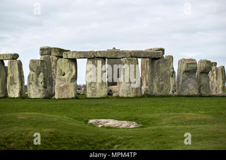 the slaughter stone in front of view of circle of sarsen stones with lintel stones stonehenge wiltshire england uk