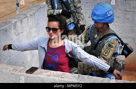 Spc. Maria Hutchinson, a military police officer with the 57th Military Police Company, 728th Military Police Battalion, 8th Military Police Brigade, performs a search on a Nepalese citizen during exercise Shanti Prayas III. Shanti Prayas is a multinational United Nations peacekeeping exercise designed to provide pre-deployment training to U.N. partner countries in preparation for real-world peacekeeping operations. (U.S. Army photo by Staff Sgt. Michael Behlin) Stock Photo