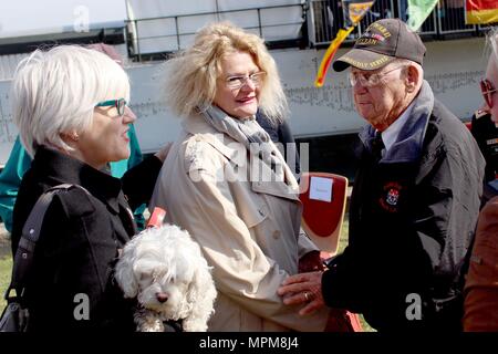 Helen Patton, left, the granddaughter of U.S. Army Gen. George Patton and Catherine Rommel, center, the granddaughter of German Field Marshall Erwin Rommel, speak to Robert Shelado, right, a World War II veteran who was present for the crossing of the Rhine River at Nierstein, Germany, Saturday, March 24, 2017 in Nierstein Germany. Americans and Germans gathered for the dedication ceremony for a monument to the 249th Engineer Combat Battalion’s efforts at the end of World War II, building a bridge across the river near Nierstein during an operation that helped shorten the war.  (Photo by Lt. C Stock Photo