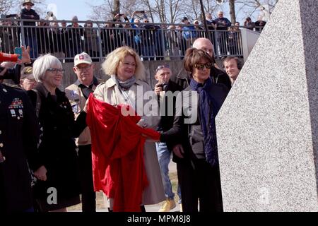 Helen Patton, left, the granddaughter of U.S. Army Gen. George Patton; Catherine Rommel, center, the granddaughter of German Field Marshall Erwin Rommel; Luci Schey, president of the Ralph and Luci Schey Foundation, examine a memorial to the Soldiers of the 249th Engineer Combat Battalion Saturday, March 24, 2017 in Nierstein Germany. (Photo by Lt. Col. Jefferson Wolfe) Stock Photo