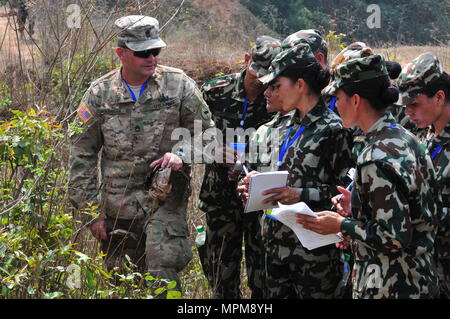 Sgt. 1st Class Christopher Warhawk helps soldiers from the Nepalese Army identify an improvised explosive device during Multinational Peacekeeping Exercise Shanti Prayas III March 24 at the Birendra Peace Operations Center in Panchkhal, Nepal. Shanti Prayas is a multinational United Nations peacekeeping exercise designed to provide pre-deployment training to U.N. partner countries in preparation for real-world peacekeeping operations. (U.S. Army photo by Staff Sgt. Michael Behlin) Stock Photo