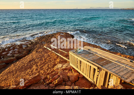 Traditional boathouse by the sea near Cala Saona with Es Vedrá islet and Ibiza island in the distance from Formentera (Balearic Islands, Spain) Stock Photo