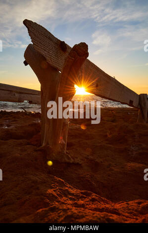 Traditional wood dry dock by the sea with sunbeam at sunset from Caló d’en Trull near Cala Saona (Formentera,Balearic Islands,Mediterranean Sea,Spain) Stock Photo